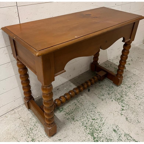 67 - A side table on bobbin style legs (H76cm W100cm D44cm)