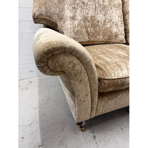 7 - A two seater fawn upholstered sofa