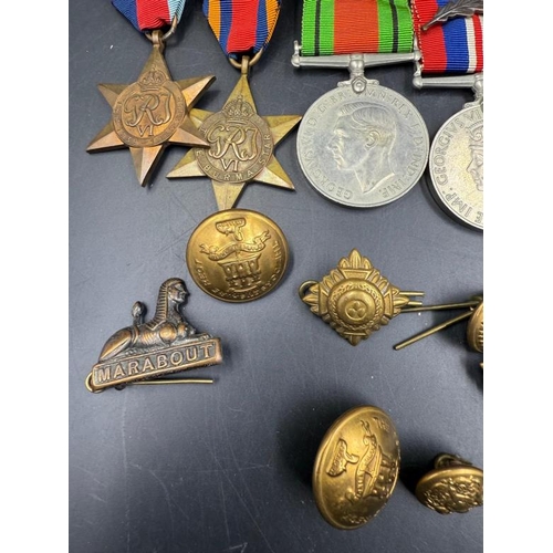 704 - WWII medals and additional insignia cap badges etc for the Dorsetshire Reg to include The Defence Me... 