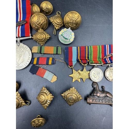 704 - WWII medals and additional insignia cap badges etc for the Dorsetshire Reg to include The Defence Me... 