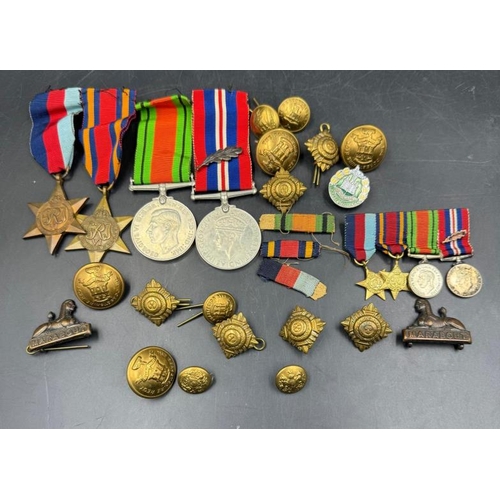 704 - WWII medals and additional insignia cap badges etc for the Dorsetshire Reg to include The Defence Me... 