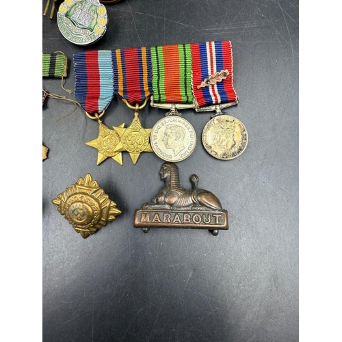 704 - WWII medals and additional insignia cap badges etc for the Dorsetshire Reg to include The Defence Me... 