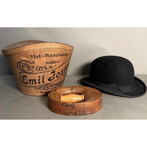 727 - A Georg Fischer bowler hat, a hat stretcher and a Emil Fester silk Top Hat in original box