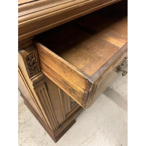 73 - An oak sideboard with two drawers and two carved panel doors below  (H97cm W150cm D54cm)