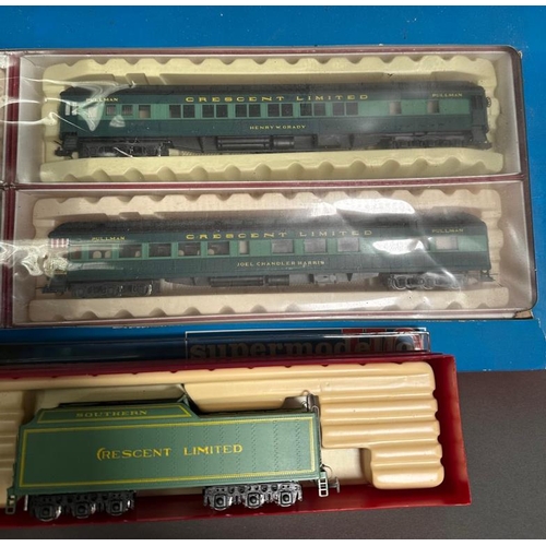 753 - A boxed Rivarossi steam engine and coal car and a box of four Rivarossi trains