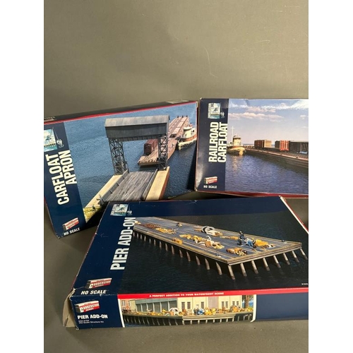 760 - Five boxed corner store model railway layout buildings, bridges and car floats