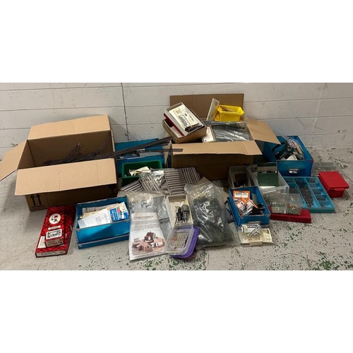 781 - A large quantity of model railway layouts, train accessories and parts