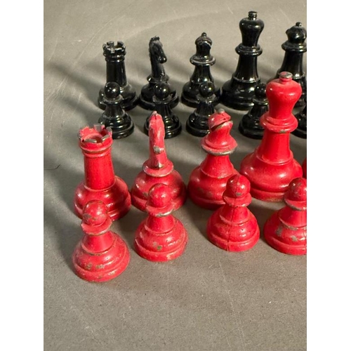 805 - A set of lead chess pieces in red and black