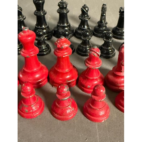 805 - A set of lead chess pieces in red and black