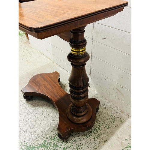 87 - A mahogany Revival twin reading table with a double book rest, adjustable turned stem on a solid bas... 