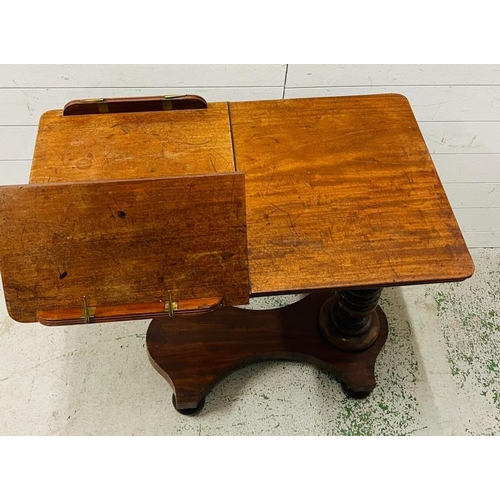 87 - A mahogany Revival twin reading table with a double book rest, adjustable turned stem on a solid bas... 