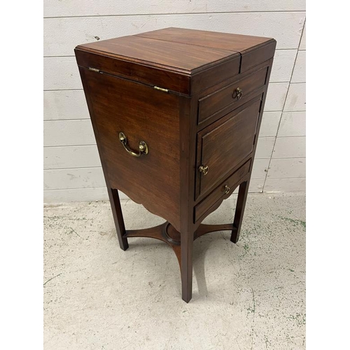 88 - A Georgian mahogany fold over top wash stand cupboard, standing on square section legs with the stre... 