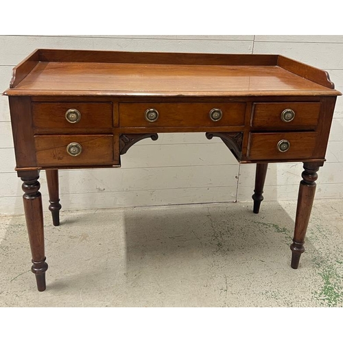 94 - A ladies Victorian writing desk with galleried top over an arrangement of drawers, knee hole shaped ... 