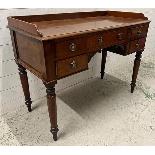 94 - A ladies Victorian writing desk with galleried top over an arrangement of drawers, knee hole shaped ... 