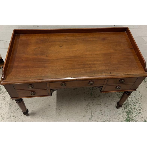 94 - A ladies Victorian writing desk with galleried top over an arrangement of drawers, knee hole shaped ... 