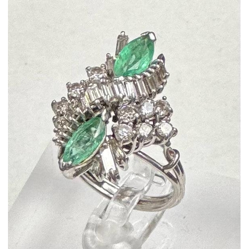 620 - An emerald and diamond ring, designed a s a vertically set elongated cluster with two marquise cut e... 