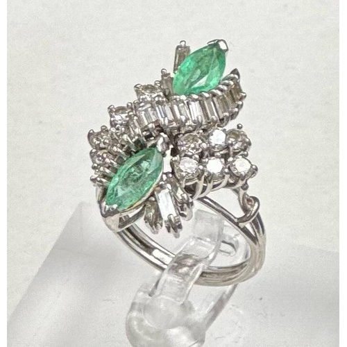 620 - An emerald and diamond ring, designed a s a vertically set elongated cluster with two marquise cut e... 