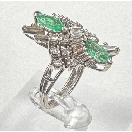 620 - An emerald and diamond ring, designed a s a vertically set elongated cluster with two marquise cut e... 