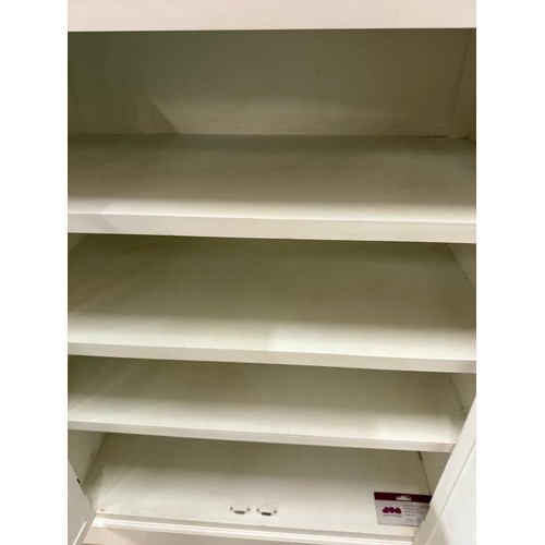 104 - A white wall unit with two vented drawers above two panelled doors opening to shelves (H120cm W80cm ... 