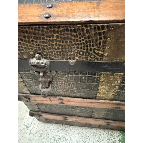 108 - A Victorian steamer trunk, the chest with with its dome top and wooden and metal banding and faux cr... 