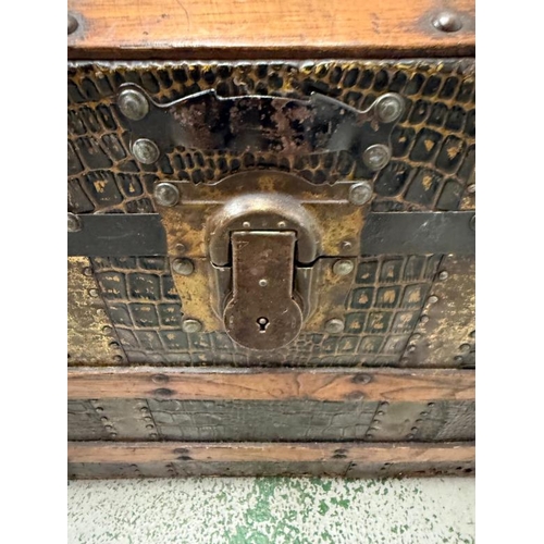 108 - A Victorian steamer trunk, the chest with with its dome top and wooden and metal banding and faux cr... 