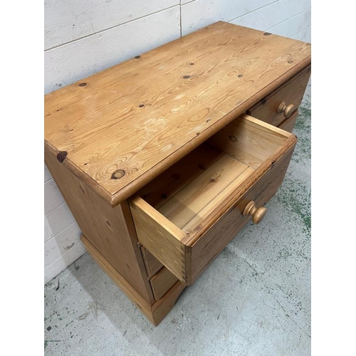 113 - Tow over two pine chest of drawers with a shaped bracket foot (H77cm W92cm D45cm)