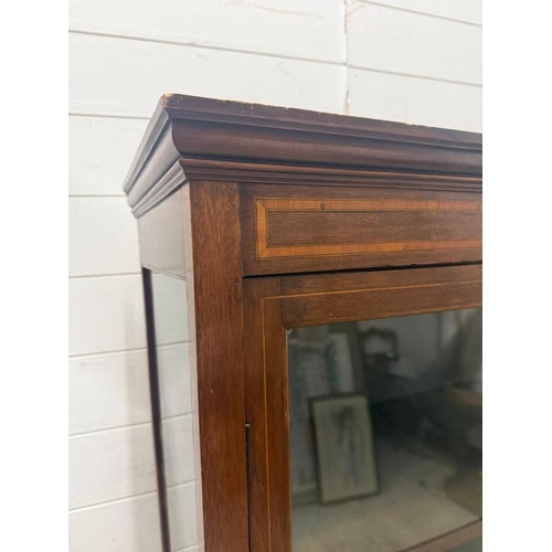 122 - An Edwardian style mahogany glazed display cabinet with string inlay, two shelves and two drawers un... 