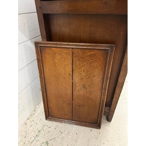 127 - An oak butlers companion or sideboard with heavily carved panels to front, comprising of single draw... 