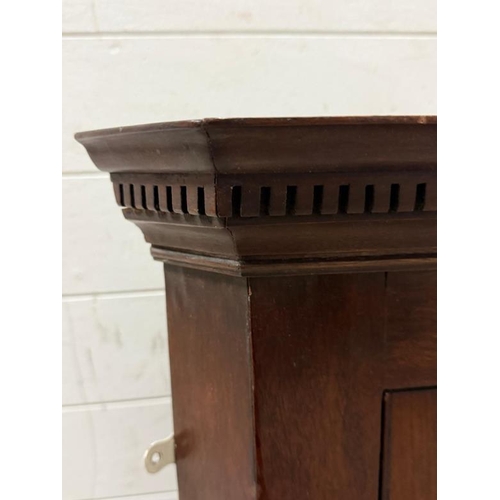 128 - A small mahogany astragal glazed corner cabinet. Height 77 Depth 34