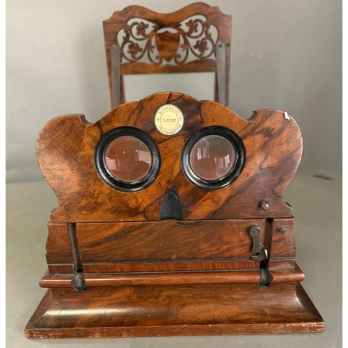 143 - A Victorian Graphoscope by Rowsell's with a scrolling carved sliding screen and folding view finder