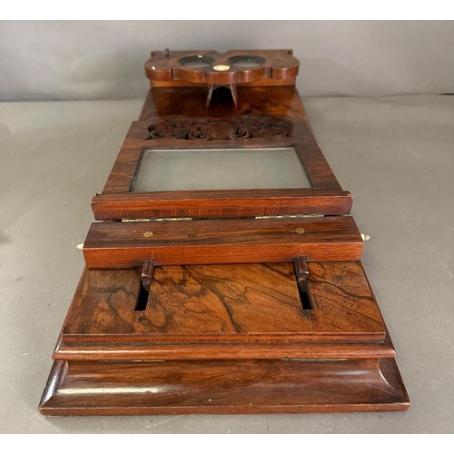 143 - A Victorian Graphoscope by Rowsell's with a scrolling carved sliding screen and folding view finder