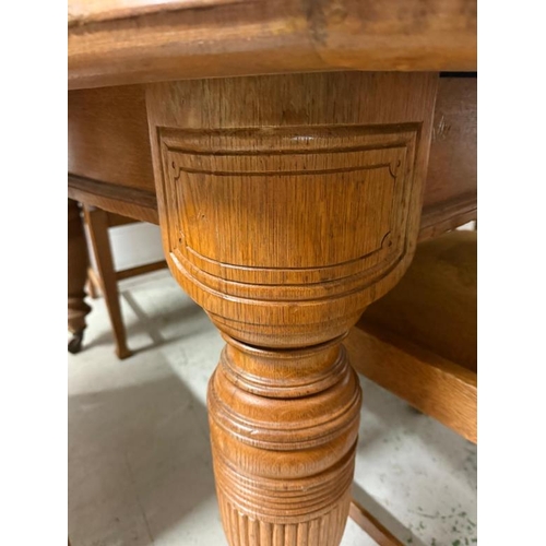 149 - A light oak extendable three leaf dining table on turned and fluted baluster legs and eight Arts and... 