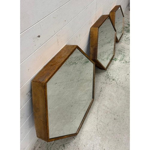 196 - Three graduated hexagonal wall mirrors in copper effect frames