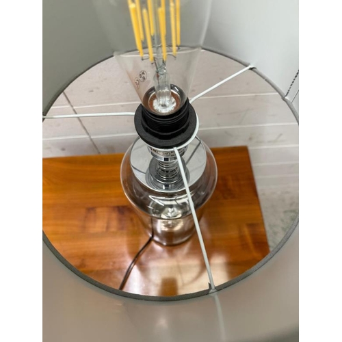 217 - A smoked glass and chrome table lamp