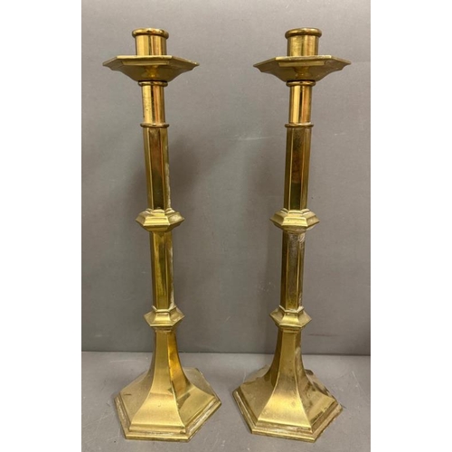 219 - A pair of church style brass candlesticks