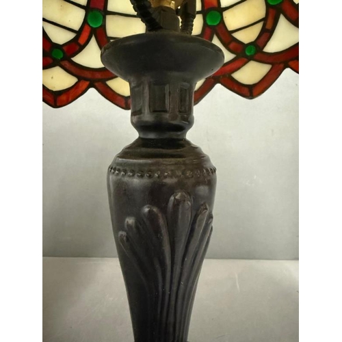 223 - An Art Deco style lamp with Tiffany style shade in white red and green stained glass