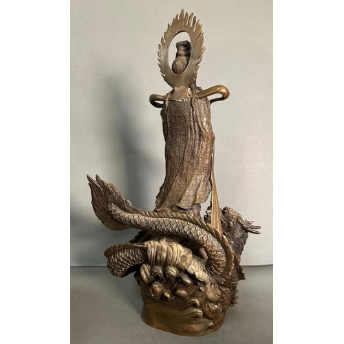 242 - A Chinese brass statue of the dragon god riding a dragon with bottle in hand and offering the sign o... 