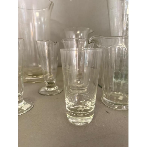 256 - A selection of etched glass measures of various sizes and ages