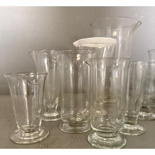 256 - A selection of etched glass measures of various sizes and ages