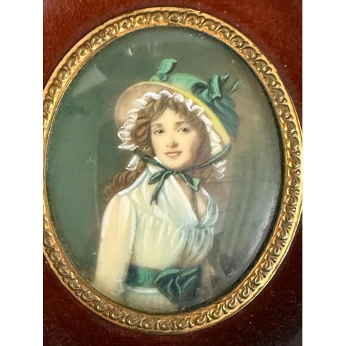 360 - A mahogany framed miniature of a young lady in a bonnet