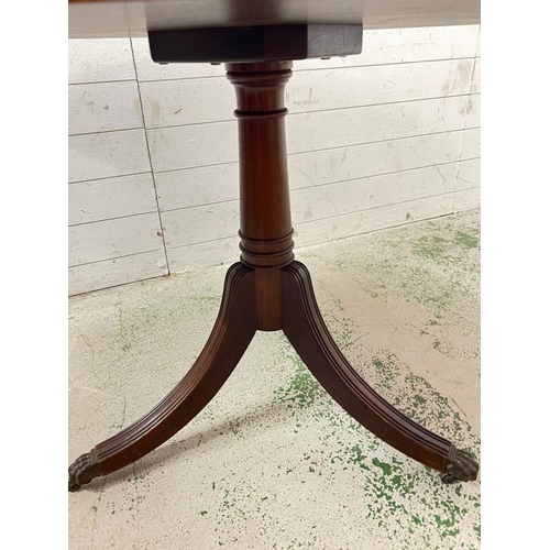 4 - A Regency style circular centre table on turned column stem raised on down swept legs and lion paw c... 