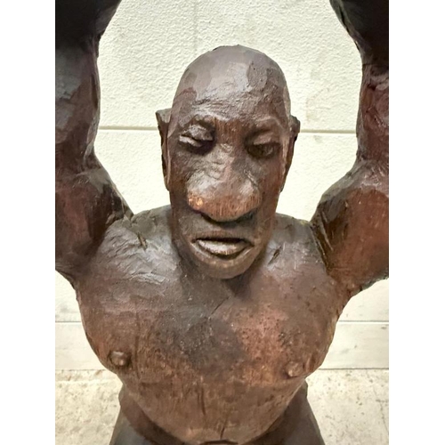 409 - A South African hardwood carving of a weight lifter H53cm