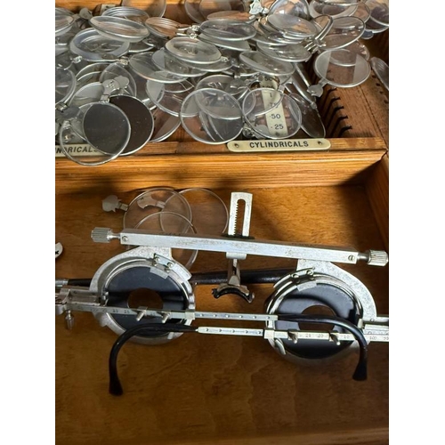 436 - A vintage opticians set with glasses and lenses in a fitted pine box