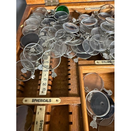 436 - A vintage opticians set with glasses and lenses in a fitted pine box