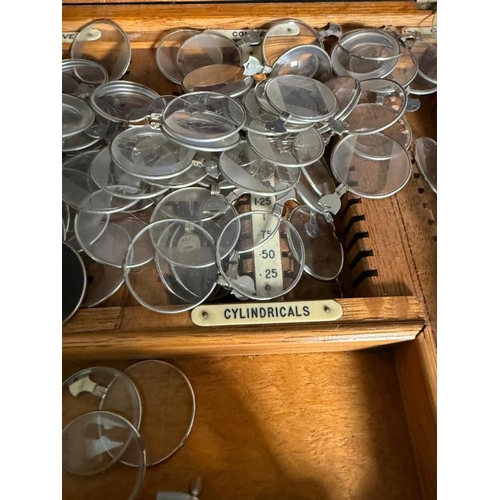 436 - A vintage opticians set with glasses and lenses in a fitted pine box