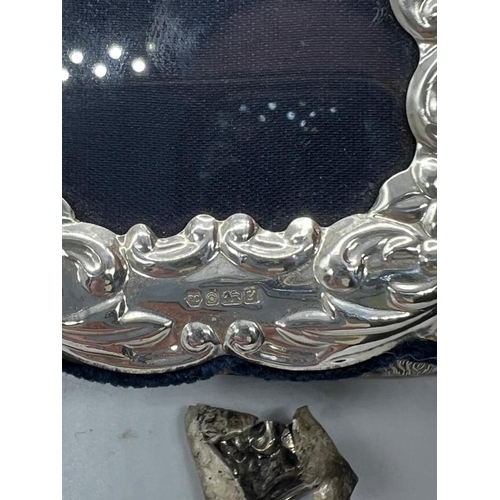 471 - A silver necked scent bottle along with a small, 9.5cm H, easel backed hallmarked picture frame and ... 