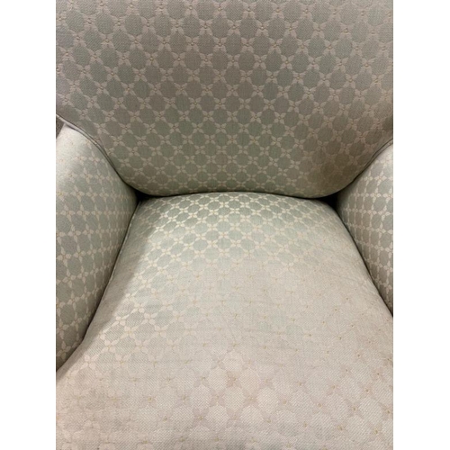 48 - A lounge chair and matching foot stool upholstered in pale green