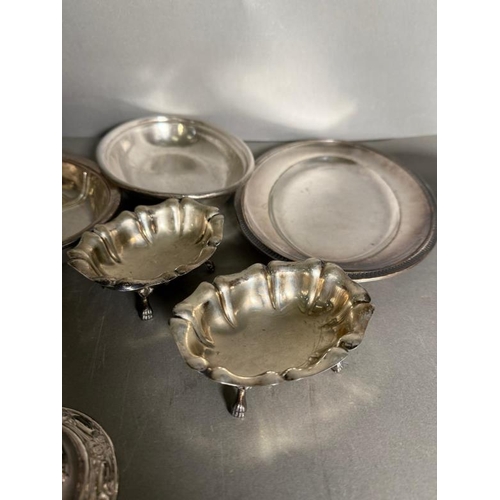 490 - A quantity of silver plate and white metal items to include pin dishes, footed bowls and candlestick... 