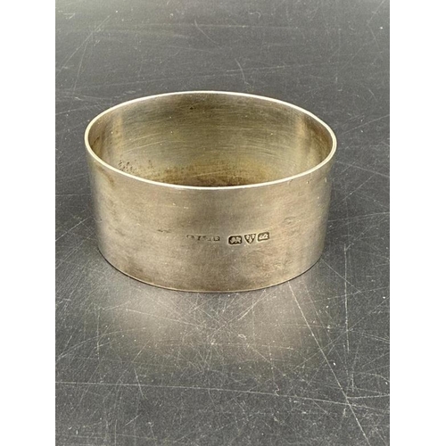 493 - A hallmarked silver napkin ring Chester 1927 along with  a Danish pair of silver sugar tongs