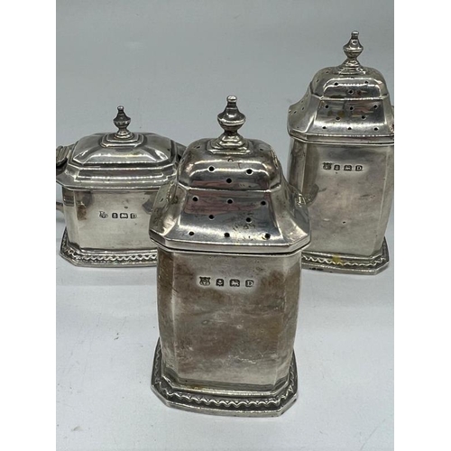 498 - A William Neale & Son silver cruet set to include a mustard, two salts with blue glass liners and tw... 